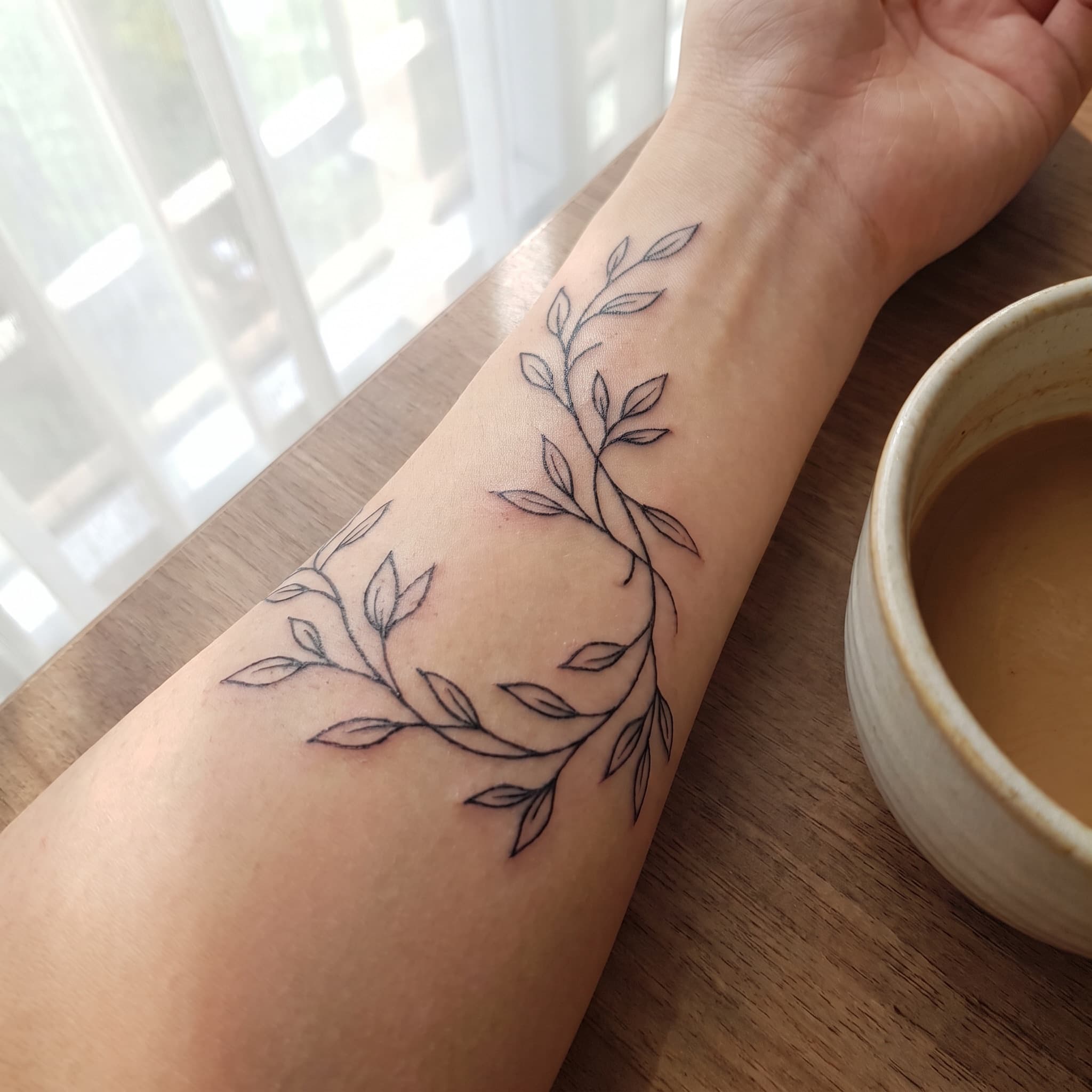 An arm, before and after a tattoo placement preview — after